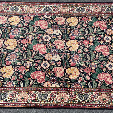 Floral rug with black field  4'6" x 7'5"