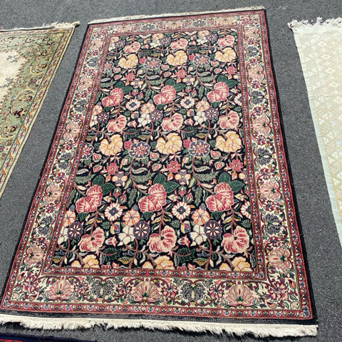 Floral rug with black field  4'6" x 7'5"