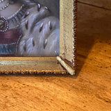 small portrait painting in bronze frame with Bow