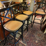 set of 4 black bar stools with woven seats