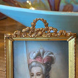 small portrait painting in bronze frame with Bow