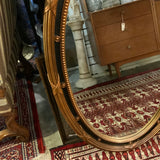black and gold decorative oval mirror
