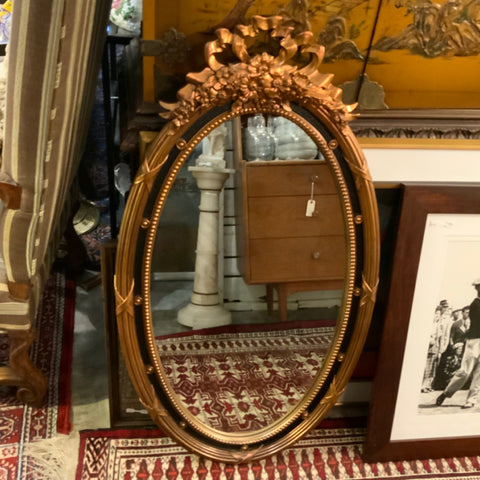 black and gold decorative oval mirror