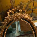 black and gold decorative oval mirror