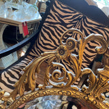 oval shaped ornate gold framed mirror