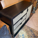 Crate and Barrel black caned chest of 3 drawers and 1 door