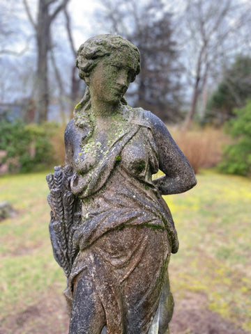 Concrete statue of classical lady on plinth