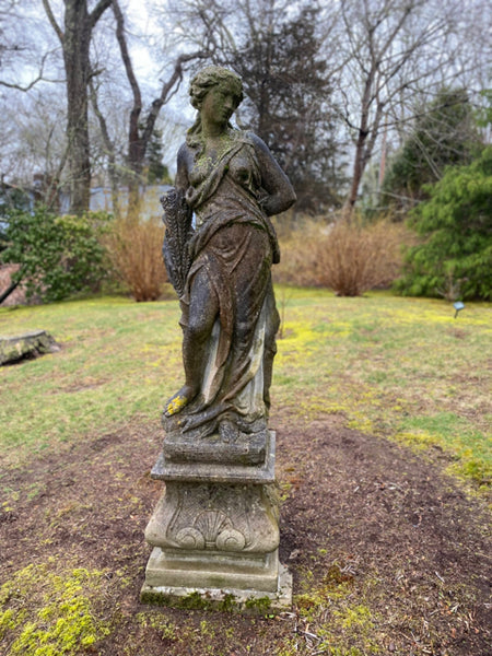 Concrete statue of classical lady on plinth