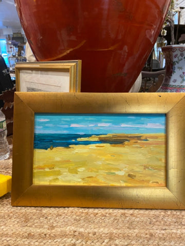 water scene painting in gold frame