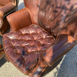 Pair of Restoration Hardware leather tufted highback arm chairs with ottoman