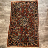 small red rug with center medallion