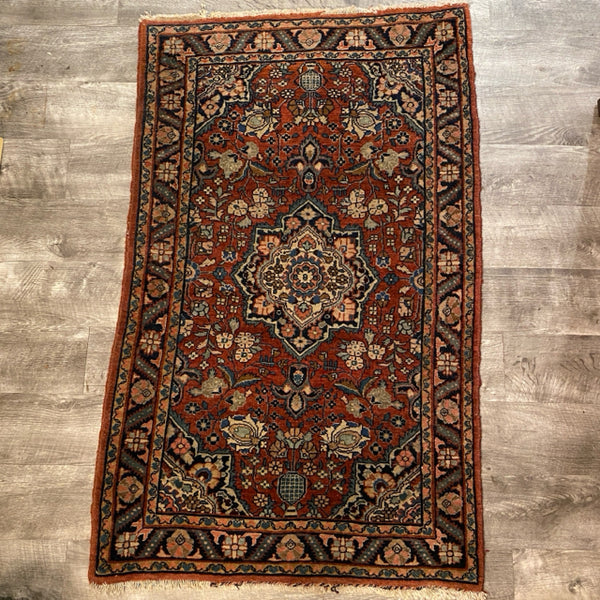 small red rug with center medallion