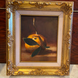 Painting of an orange in gold frame