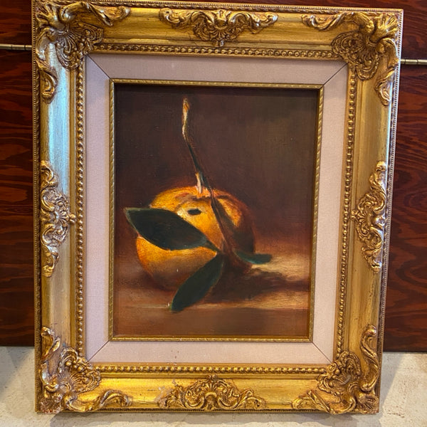 Painting of an orange in gold frame