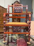 Carved caned open arm chair