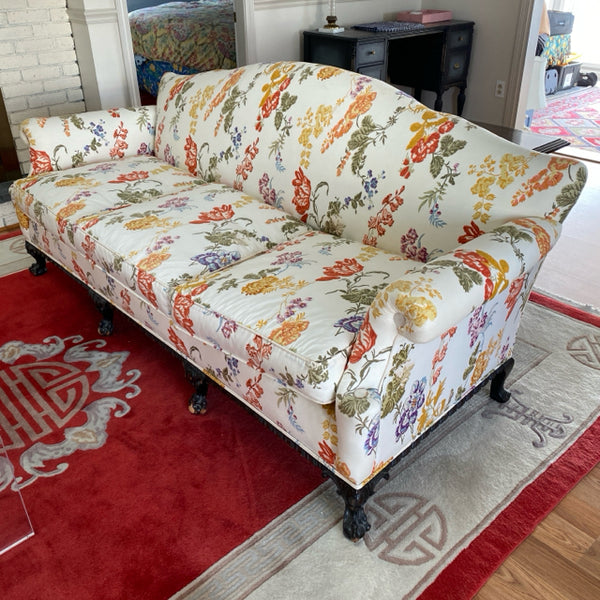 Camel back sofa custom upholstered in silk floral fabric and down cushions