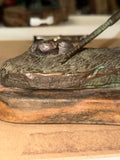 Bronze bird with worm sculpture on wood base signed Lowell Davis
