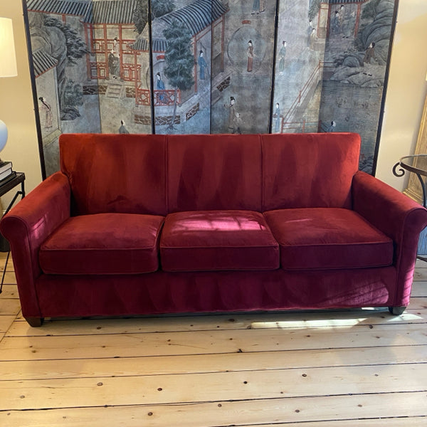 red upholstered Crate and Barrel sofa