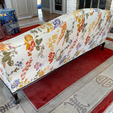 Camel back sofa custom upholstered in silk floral fabric and down cushions