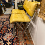 pair of chrome and yellow counter stools