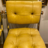 pair of chrome and yellow counter stools