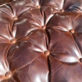 Pair of Restoration Hardware leather tufted highback arm chairs with ottoman