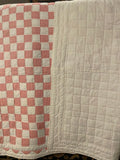 pink and white quilt