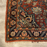 small red rug with center medallion