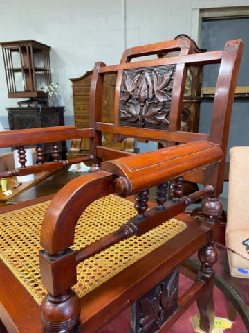 Carved caned open arm chair