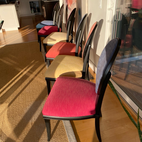 Set of 8 Roche Bobois dining chairs with black frames and multi color upholstery