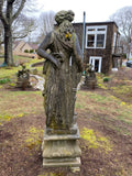 Concrete statue of classical lady on plinth