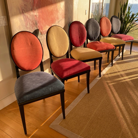 Set of 8 Roche Bobois dining chairs with black frames and multi color upholstery