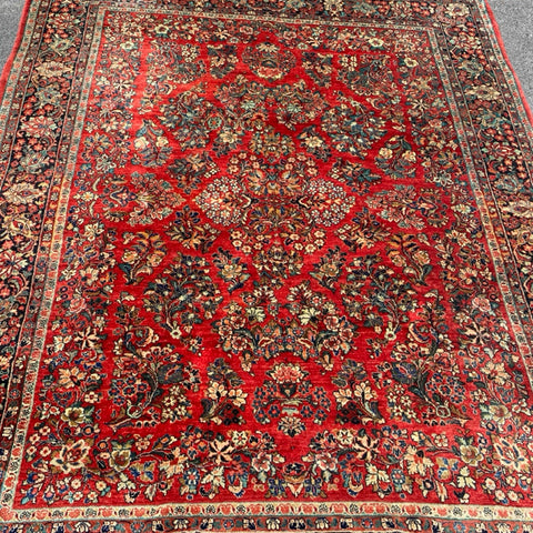1930's Sarouk floral rug with red field  7'7" x 9'7"