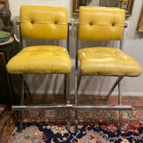 pair of chrome and yellow counter stools