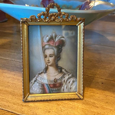 small portrait painting in bronze frame with Bow