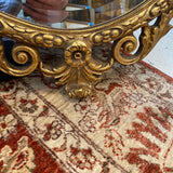 oval shaped ornate gold framed mirror