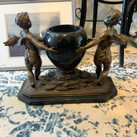 bronze cherubs holding vase