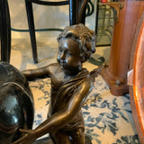 bronze cherubs holding vase